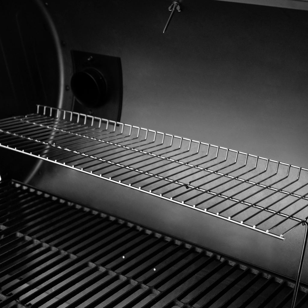 The warming rack above the main cooking grate