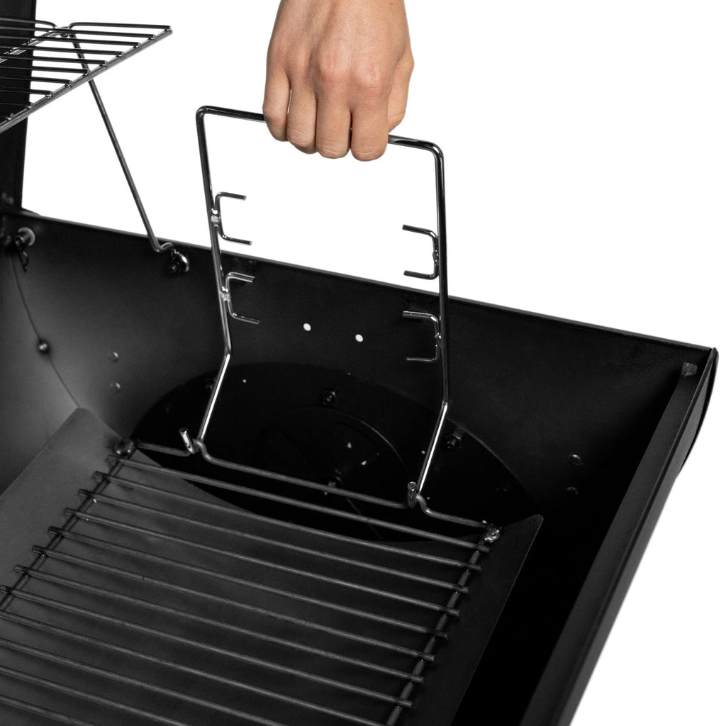 Someone adjusts the adjustable charcoal rack in the charcoal side of the grill