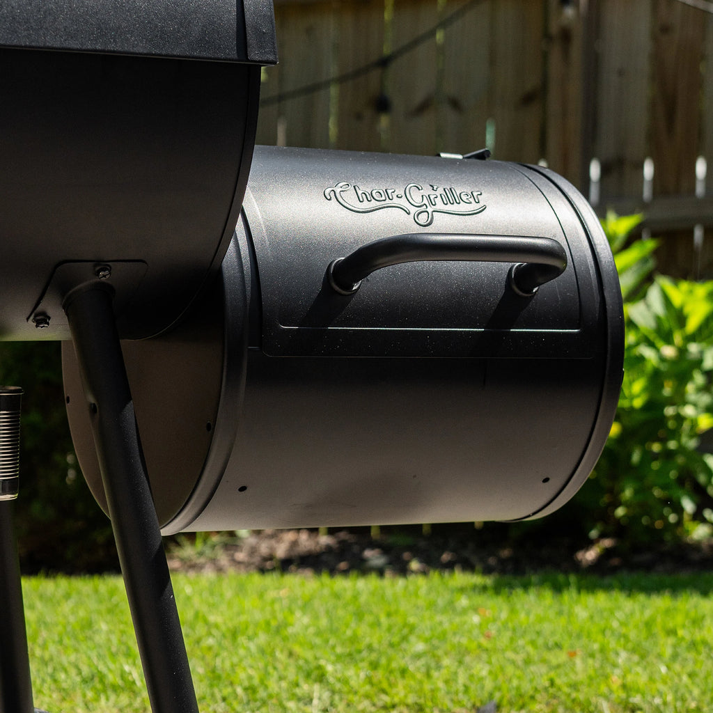 The portable grill installed as a side fire box on a full-size Char-Griller barrel grill, converting it into a Texas style offset smoker. The side fire box is attached to the larger grill so the eft damper of the fire box lines up with the bottom right damper of the grill. The legs have been removed from the side fire box for this installation.